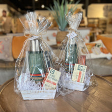 Load image into Gallery viewer, Two Custom Gift Boxes from Lit Decor and Gift sit on a round wooden table. Each box includes a green thermos, Duke Cannon soap bars, shredded white paper, and a gift tag—everything for the perfect present in a cozy space.