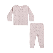 Load image into Gallery viewer, The Pointelle Long Sleeve Tee + Legging set features light pink, long-sleeved pointelle fabric with a delicate bow at the neckline, matching pants, and a subtle lilac ditsy floral pattern, displayed on a white background.