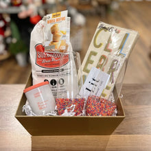 Load image into Gallery viewer, Create a Custom Gift Box from Lit Decor and Gift with a gold basket, mimosa muffin and bread mix, “Cheers” napkin set, “Clubber Mood” candle, matchbox, and two sprinkle tumblers—all arranged on a wooden surface.