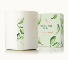 Load image into Gallery viewer, A white Lit Decor and Gift Thymes Aromatic 8 oz Candle sits beside its matching box, both featuring green watercolor basil leaves and bilingual product details, offering a refreshing Fresh-Cut Basil home fragrance.