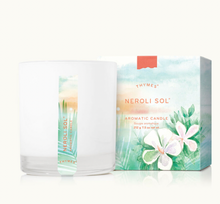 Load image into Gallery viewer, The Thymes Aromatic 8 oz Candle by Lit Decor and Gift, in a white glass jar with a vertical label, offers a clean burn and elegant neroli scent. It comes in a decorative box adorned with watercolor flowers and greenery—perfect for any home.