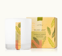 Load image into Gallery viewer, The Lit Decor and Gift Thymes Aromatic 8 oz Candle is displayed in a clear glass jar beside its decorative box with green and yellow leaf designs—ideal for refreshing home fragrance and a clean, even burn.