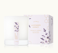Load image into Gallery viewer, A white glass Thymes Aromatic 8 oz Candle by Lit Decor and Gift is pictured beside its box, which features lavender sprigs and gold hexagons. Enjoy soft purple and gold accents with soothing scents for a clean home fragrance.