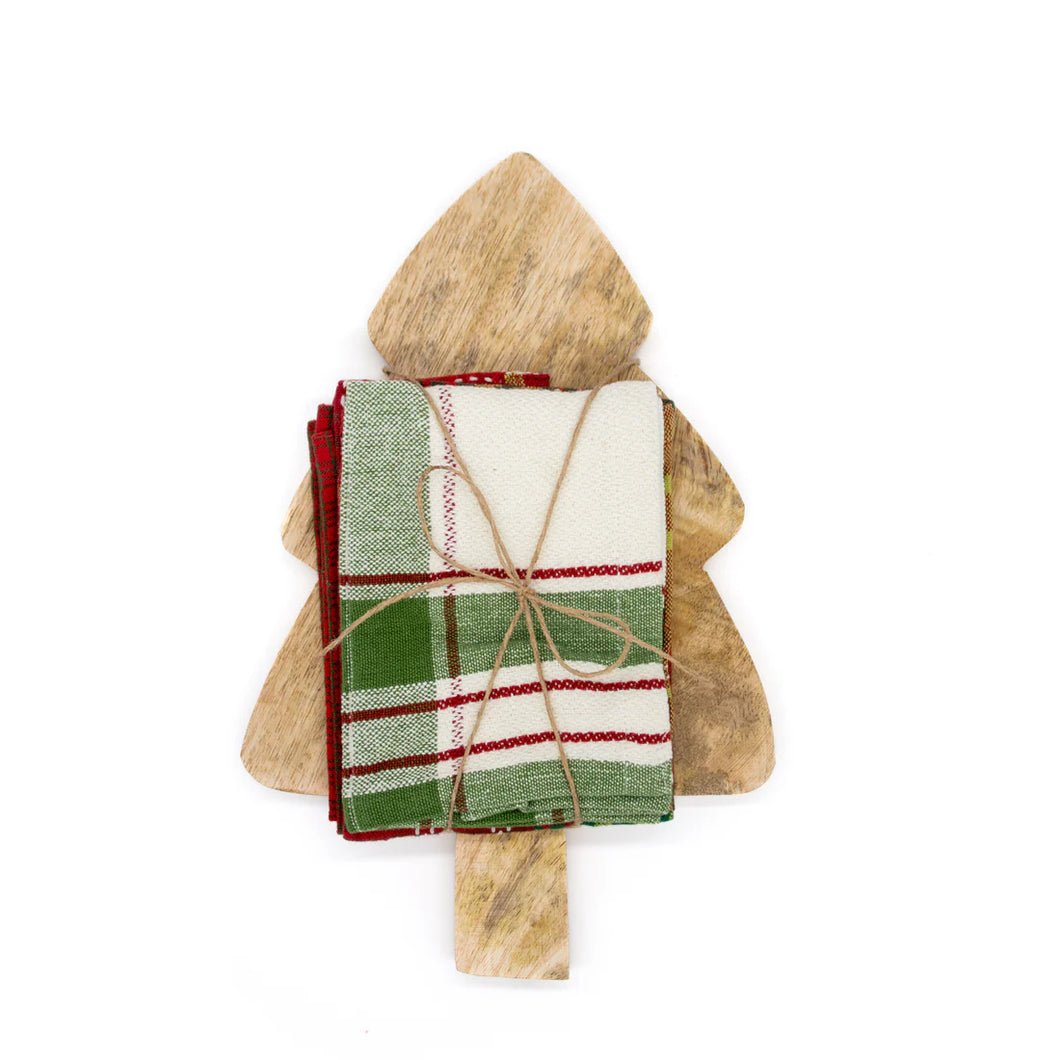 A stack of plaid Christmas napkins tied with twine rests on the Tree Board Gift Set, creating festive kitchen decor against a crisp white background.