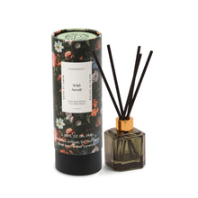 Load image into Gallery viewer, The Botanical Diffuser Set features a floral pattern, a decorative cylindrical box, and a square glass bottle with black reeds in a gold-colored cap.