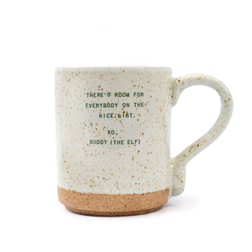 The Seasonal XO Mug is a ceramic mug with a speckled off-white glaze, unglazed bottom, and features green text: THERE’S ROOM FOR EVERYBODY ON THE NICE LIST. XO, BUDDY (THE ELF)—perfect for holiday quote fans and cozy drinks.