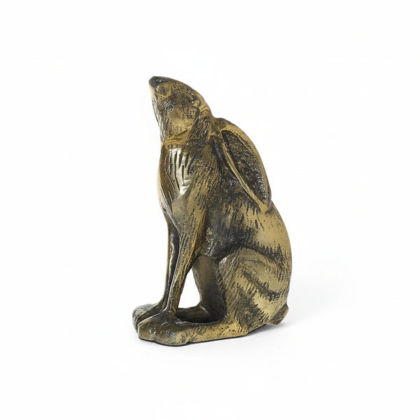 The Gold Rabbit is a small bronze sculpture of a seated hare with detailed fur, long ears, and an antiqued gold finish, making it a charming Easter décor accent against a plain white background.
