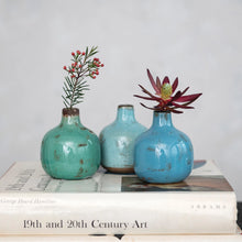 Load image into Gallery viewer, Three Terracotta Mini Vases in turquoise and blue, each with a single flower, are displayed on two stacked art books set against a light, neutral background for a vintage-inspired look.