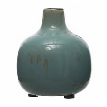 Load image into Gallery viewer, The Terracotta Mini Vase, with its rounded shape, teal-blue glaze, narrow neck, and small black feet, features subtle brownish marks and a glossy finish—perfect for adding vintage charm to farmhouse décor.