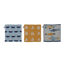 Load image into Gallery viewer, The Fish/Boat Pattern Knit Dishcloth set includes three styles: rows of sailboats on light blue, white sailboats on mustard yellow, and various fish on light blue—ideal for coastal kitchen décor.