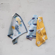 Load image into Gallery viewer, Three Fish/Boat Pattern Knit Dishcloths hang against a light textured wall: blue and yellow fish on the left, blue and red boats in the middle, and yellow with white sailboats on the right—ideal for coastal kitchen décor.