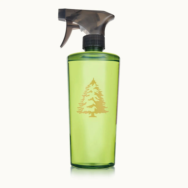 A green spray bottle with a black trigger top and a gold pine tree design on the front, from the Frasier Fir Home Care Collection, displayed against a plain white background.