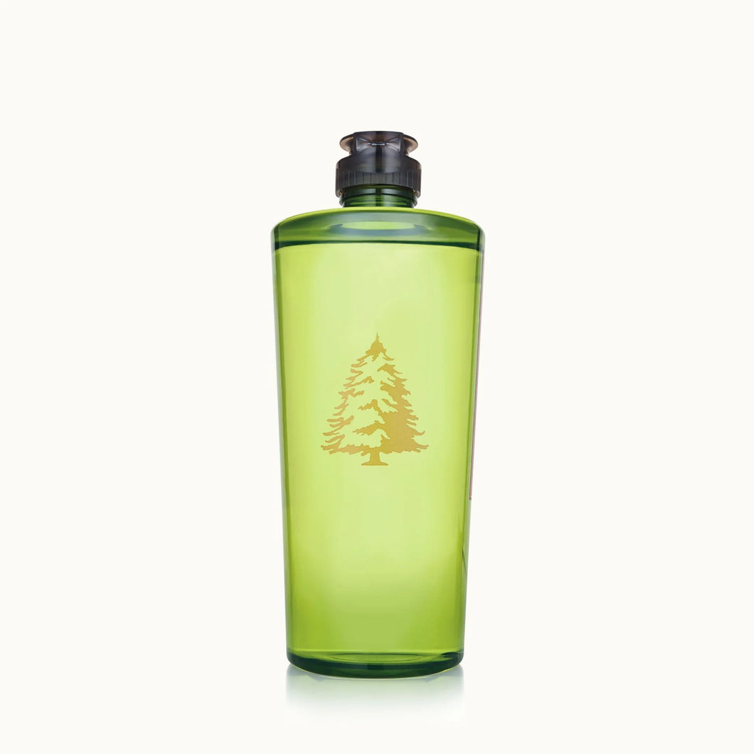 The Frasier Fir Home Care Collection features a translucent green water bottle with a black screw cap and gold pine tree graphic, inspired by the fresh scent of Frasier Fir, displayed on a simple light background.