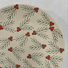 Load image into Gallery viewer, The Hand Painted Floral Holly Plate is a round handcrafted stoneware plate with a cream background, adorned with green pine branches and bright red berry clusters.