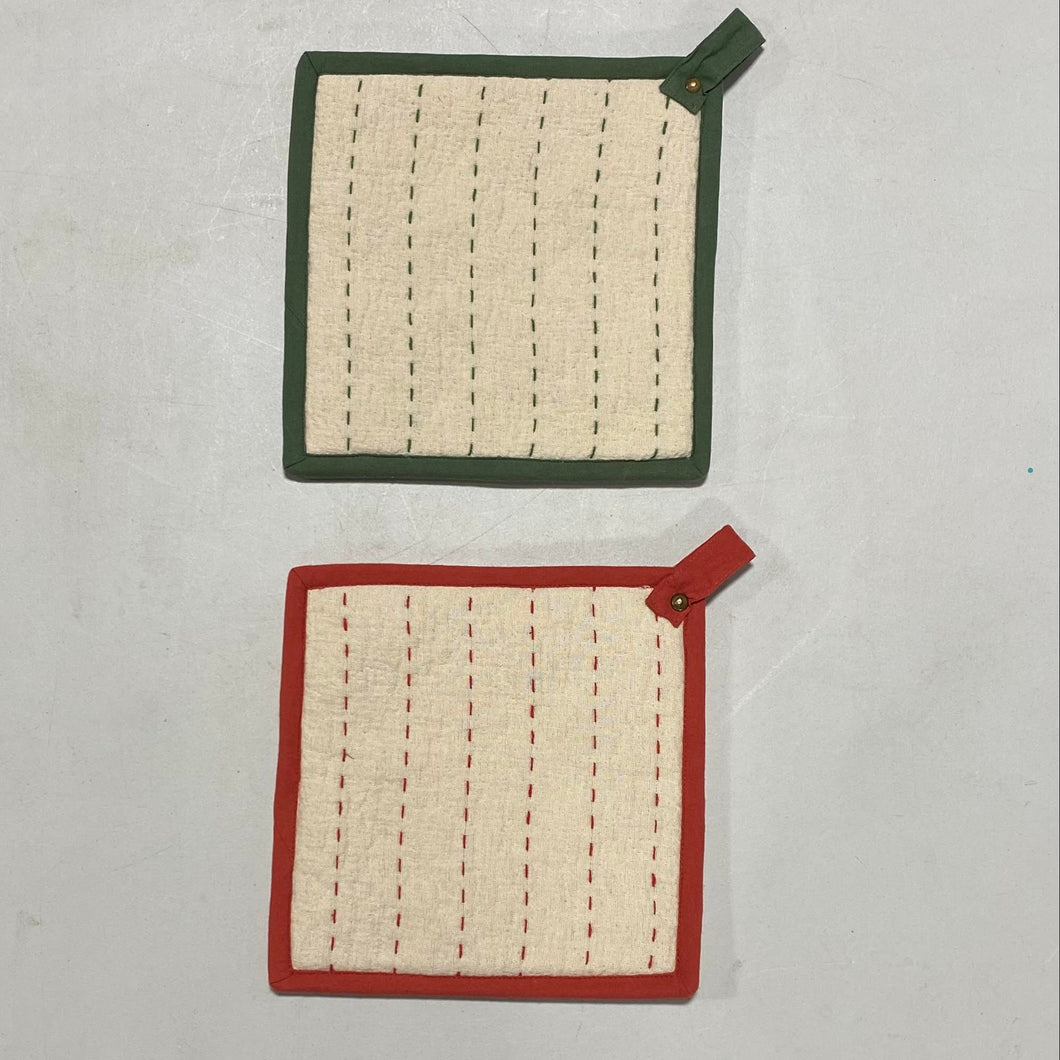Two Kantha Stitch Potholders, each square with stitched vertical lines: one has a green border and loop, the other a red border and loop. Both are displayed on a plain light surface.