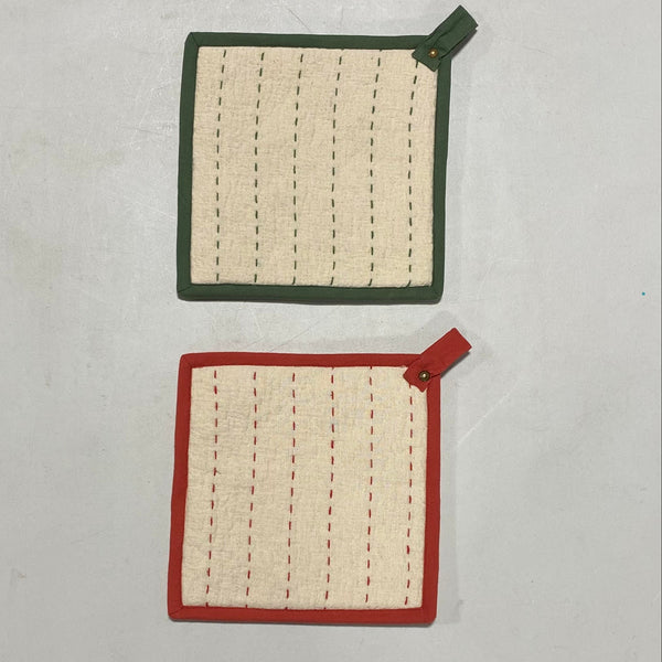 Two Kantha Stitch Potholders, each square with stitched vertical lines: one has a green border and loop, the other a red border and loop. Both are displayed on a plain light surface.