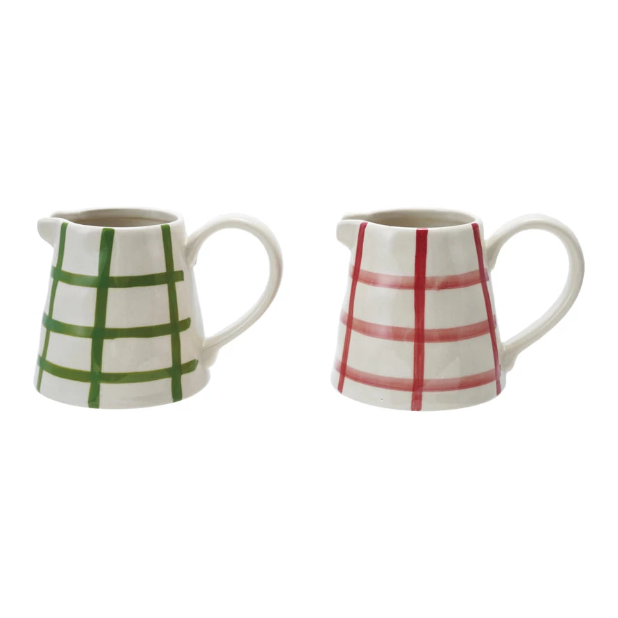 Two small Hand Painted Stoneware Creamers with a grid pattern—one with green lines, the other red—both crafted from white stoneware.
