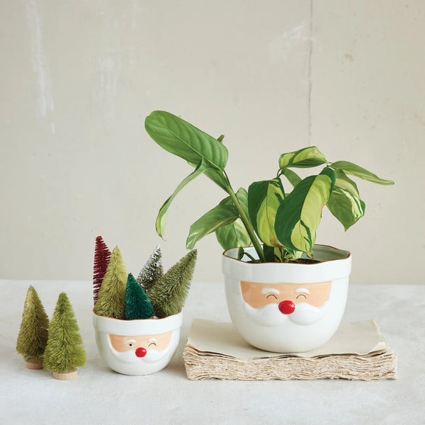 The Santa Mixing Bowl, styled with a festive plant and bottlebrush trees, brings holiday cheer and nostalgic charm to your space, inspired by the classic look of Santa during joyful holiday baking.