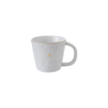 Load image into Gallery viewer, The Tree Debossed Stoneware mug is handcrafted from white ceramic, featuring a large handle and artisanal tree motifs in an embossed pattern. A central tree is accented in gold, while the rustic finish adds subtle charm.